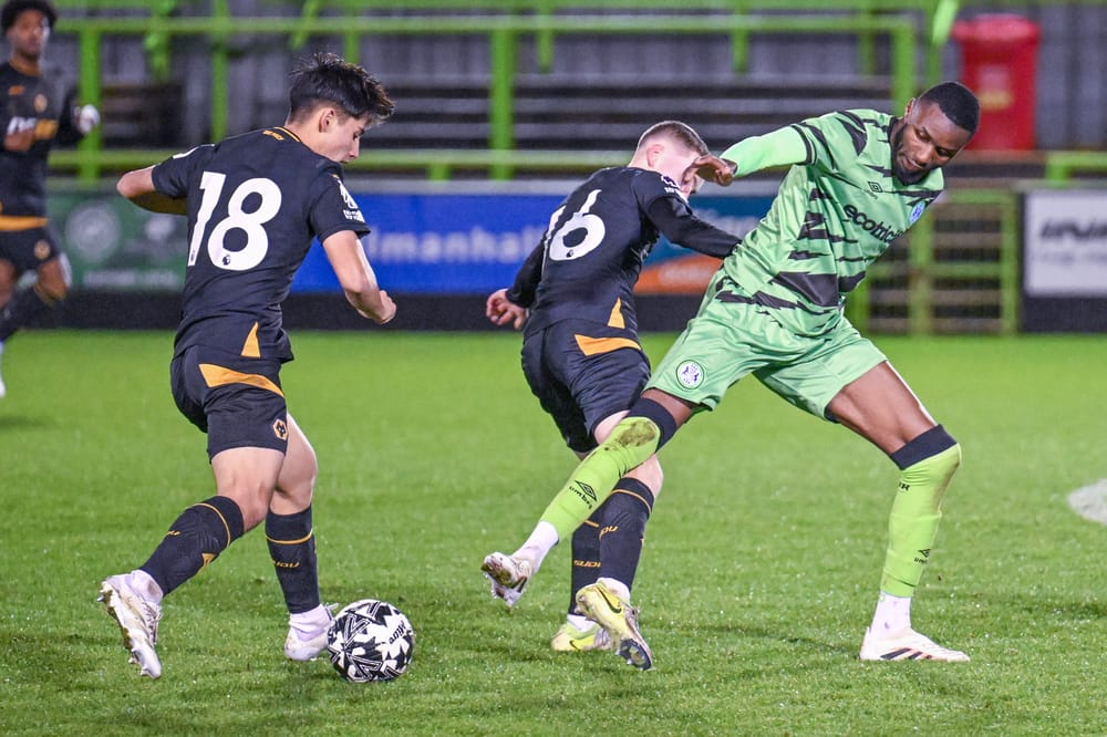 Forest Green Rovers midfielder Emmanuel Osadebe (6) is challenged by  Wolverhampton Wanderers u21s midfielder Luke Rawlings (18) &  Wolverhampton Wanderers u21s midfielder Finn Ashworth (16) during the National League Cup match between Forest Green Rovers and U21 Wolverhampton Wanderers at the The Bolt New Lawn, Forest Green, United Kingdom on 18 December 2024.
