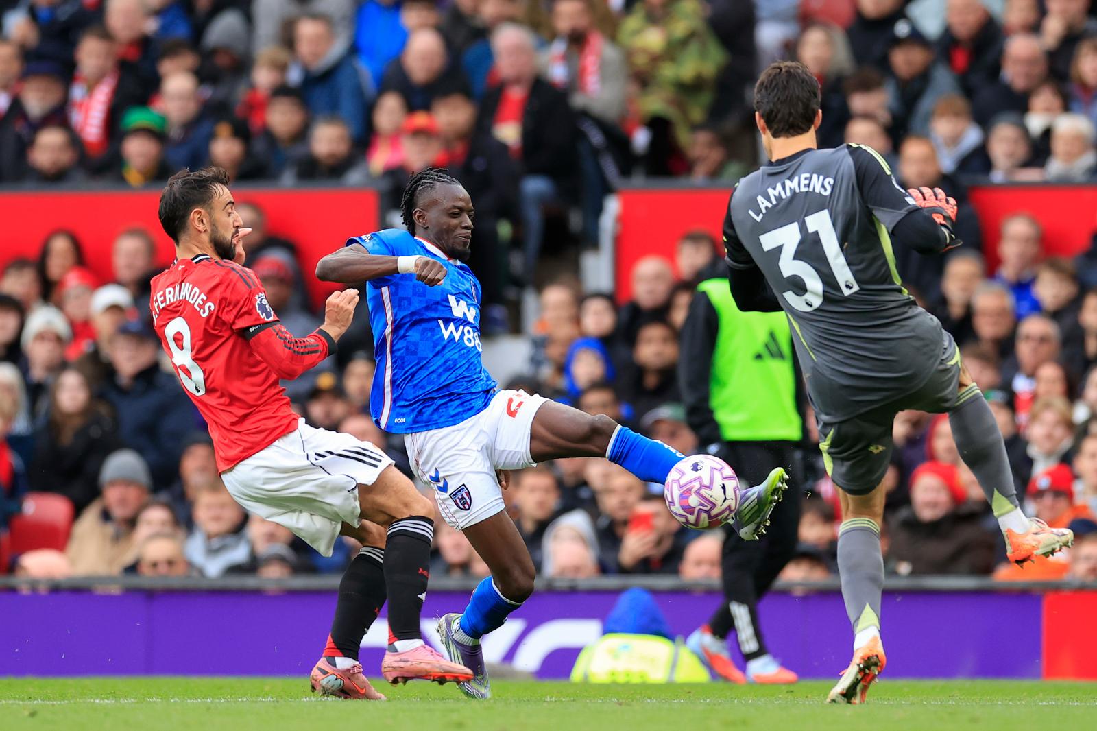Bertrand Traore (25) of Sunderland is challenged by Senne Lammens (31) of Manchester United during the Premier League match between Manchester United and Sunderland at Old Trafford, Manchester, England on 4 October 2025.